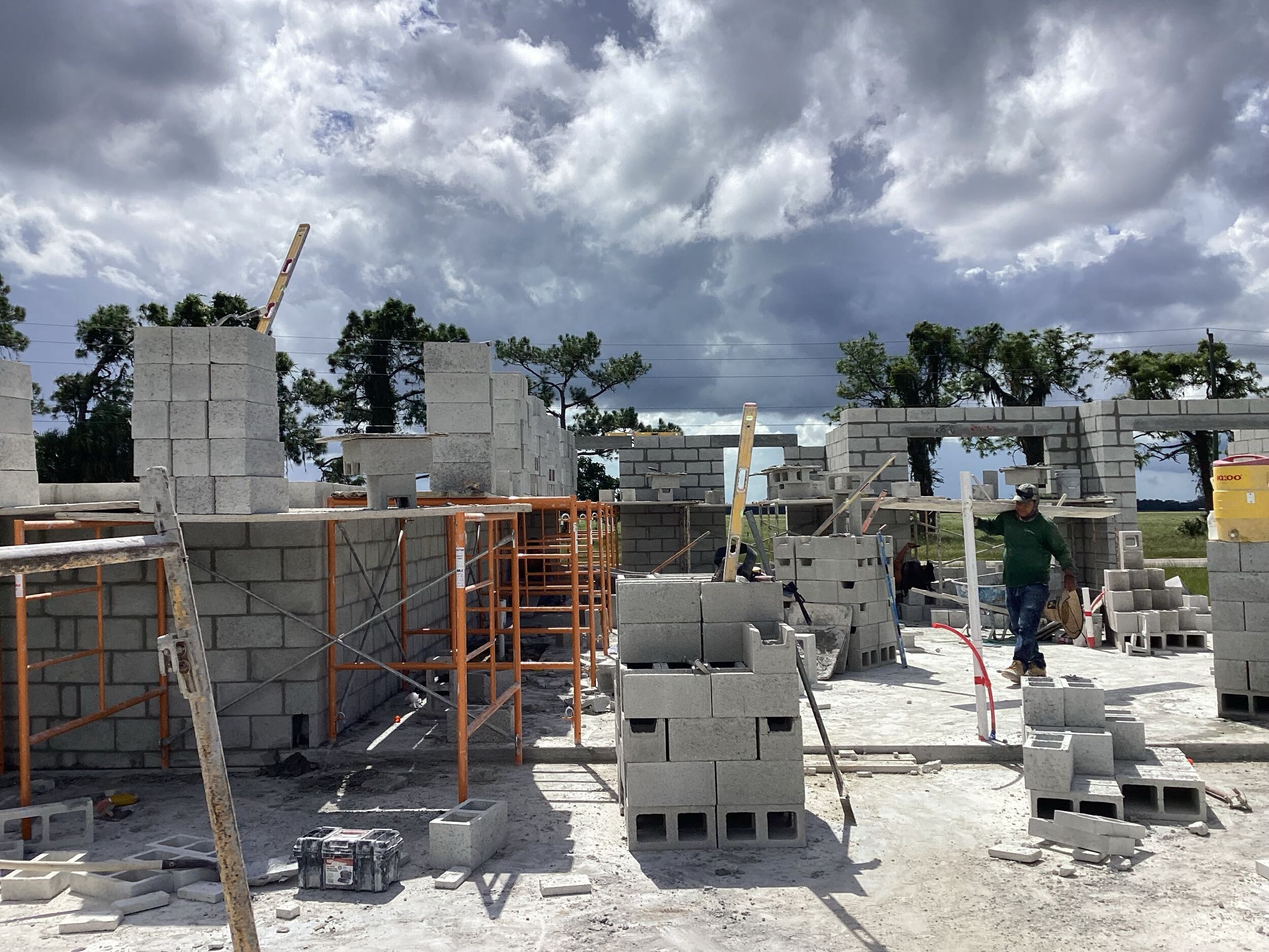 Residential construction site with concrete block walls and scaffolding