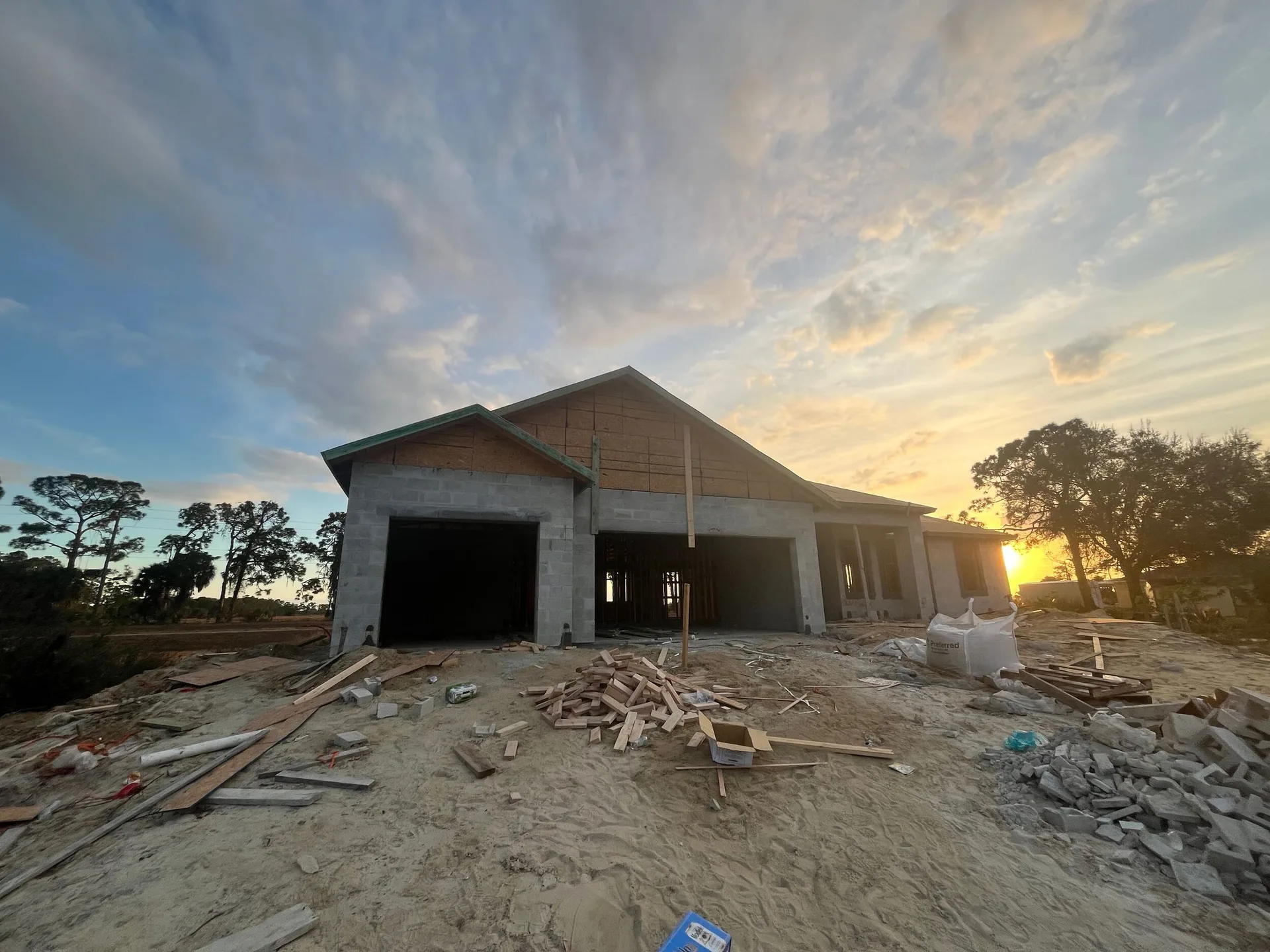 New home construction interior with roof trusses and natural light